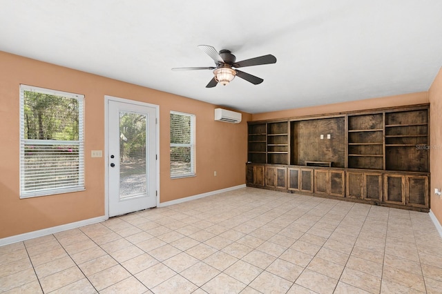 empty room with light tile patterned floors, baseboards, a wall mounted air conditioner, and ceiling fan