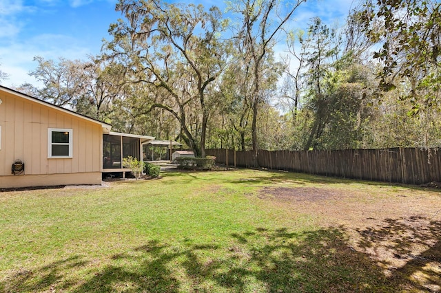 view of yard with a sunroom and fence