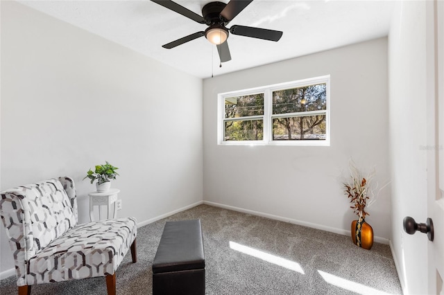 sitting room featuring baseboards, carpet floors, and ceiling fan