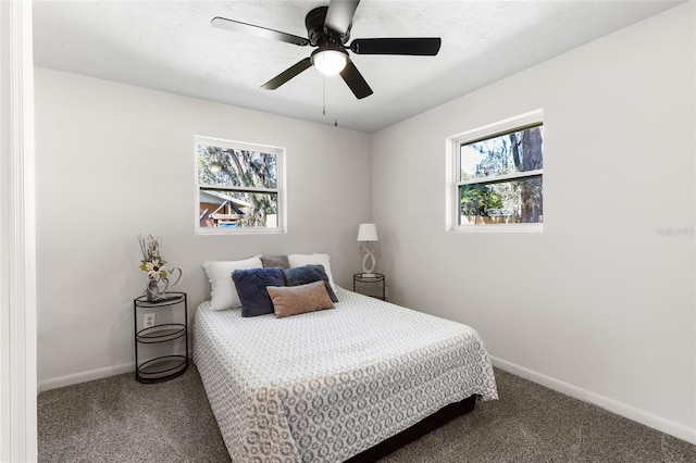 carpeted bedroom with baseboards and ceiling fan