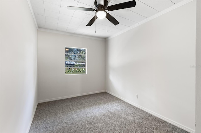 spare room with a ceiling fan, baseboards, carpet, and crown molding