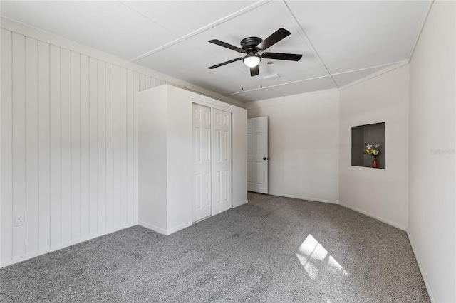 unfurnished bedroom featuring carpet, a closet, and ceiling fan