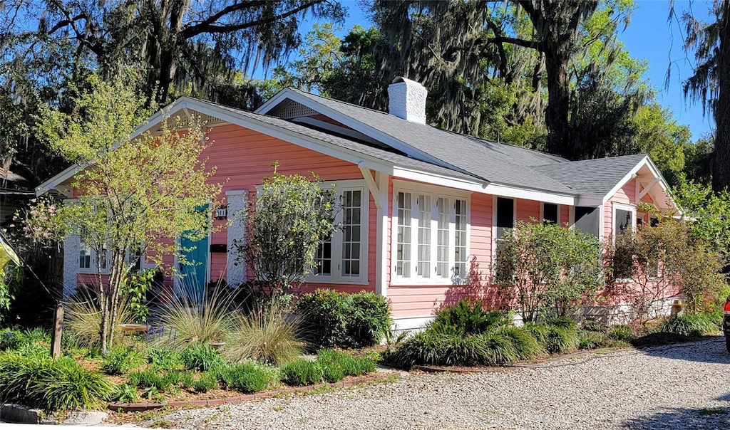 view of front of house featuring a chimney