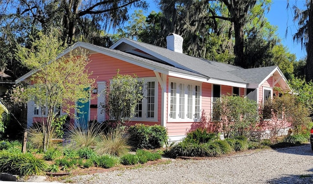 view of front of house featuring a chimney