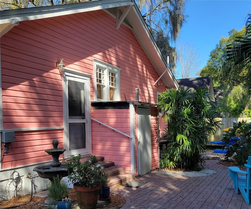 view of side of property with a patio and fence