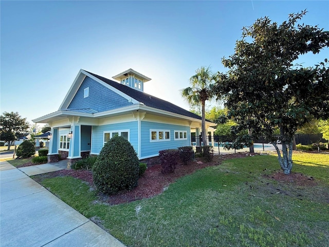 view of property exterior with a yard and fence