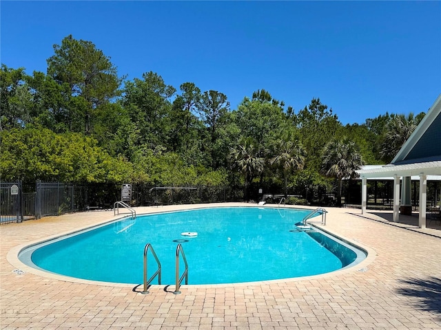 pool with fence, a patio area, and a pergola