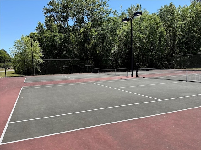 view of sport court featuring community basketball court and fence