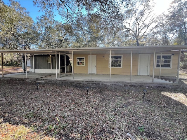 view of front of property with a carport and a patio