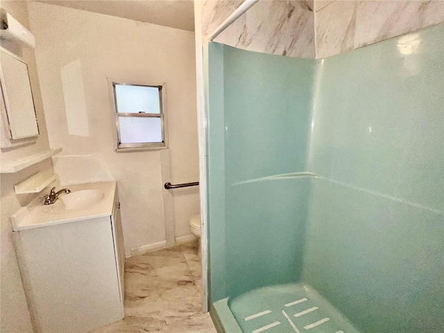 bathroom featuring a shower, toilet, marble finish floor, and vanity