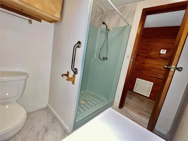 bathroom with toilet, visible vents, marble finish floor, and a stall shower