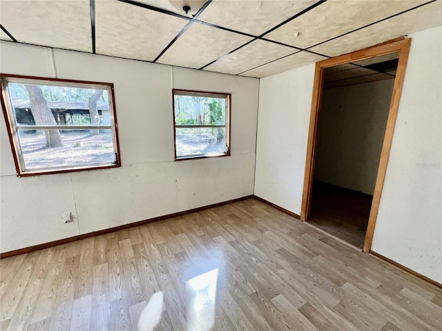 unfurnished bedroom with baseboards and light wood-style floors