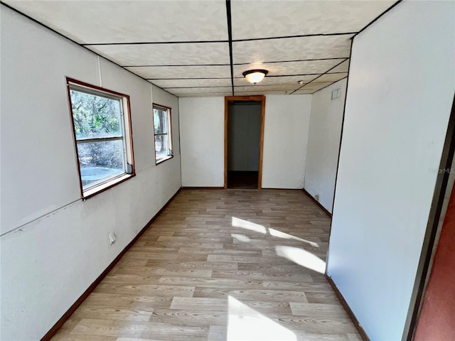 empty room with light wood-style flooring and baseboards