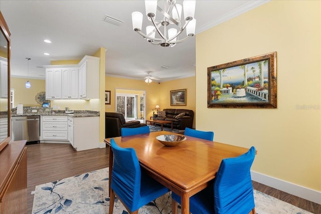 dining space with visible vents, baseboards, dark wood-type flooring, and crown molding