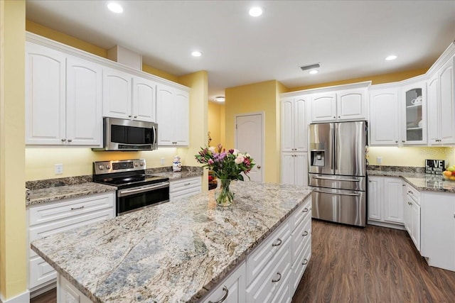 kitchen with recessed lighting, appliances with stainless steel finishes, dark wood-style floors, and white cabinetry