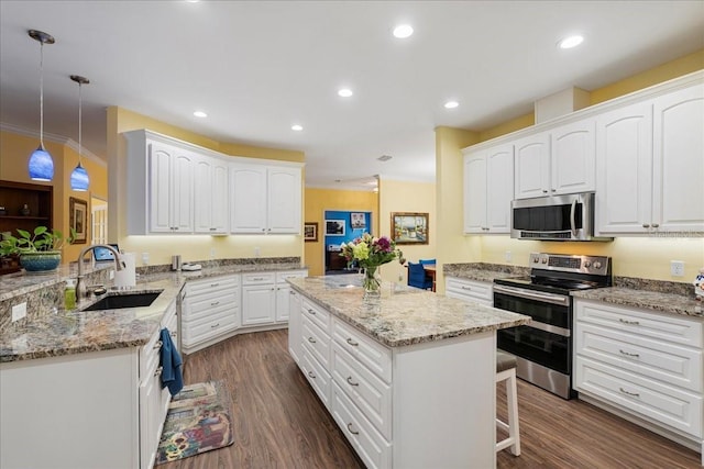 kitchen featuring a sink, a kitchen island, light stone countertops, stainless steel appliances, and dark wood-style flooring