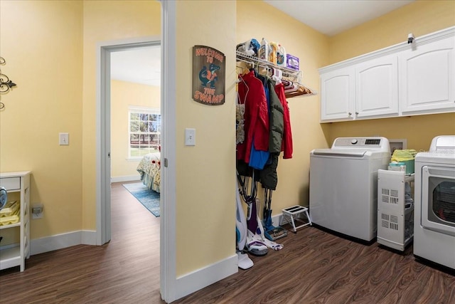 clothes washing area with baseboards, cabinet space, independent washer and dryer, and dark wood-style floors