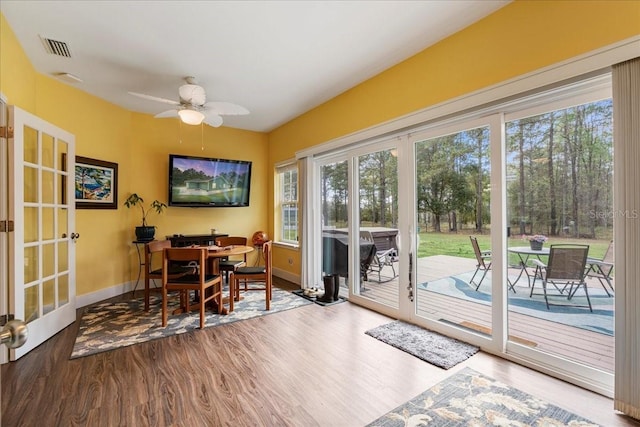 dining space with visible vents, french doors, baseboards, and wood finished floors