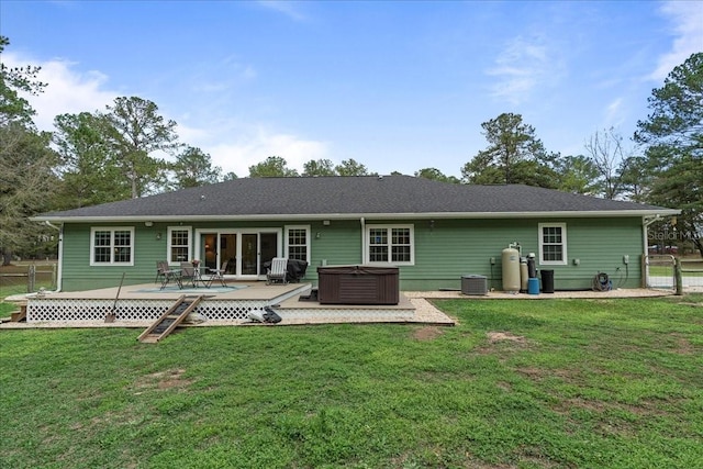 back of house with a wooden deck, central AC unit, a hot tub, and fence