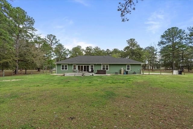 rear view of house featuring a yard