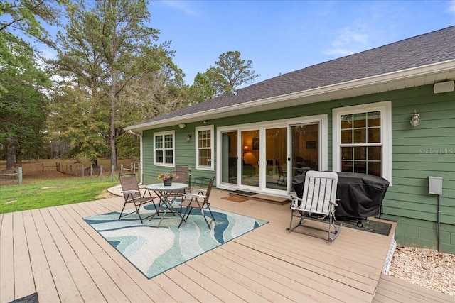 wooden deck with a grill