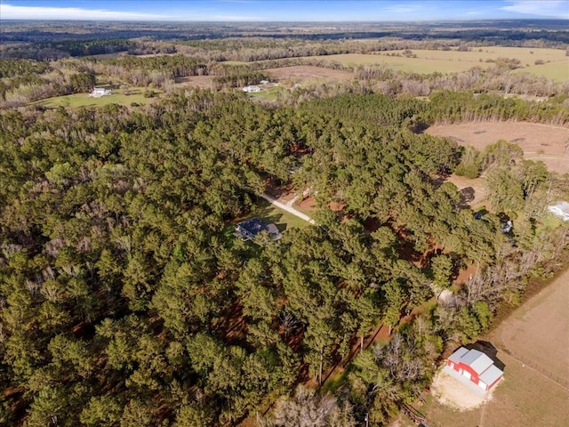 birds eye view of property with a forest view