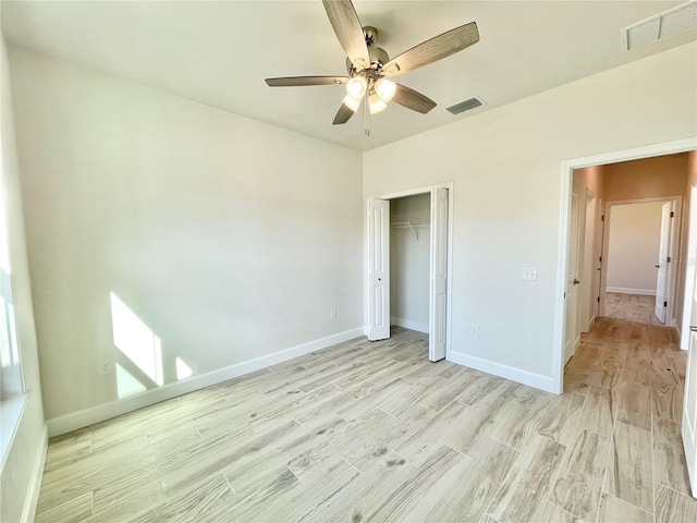 unfurnished bedroom featuring baseboards, visible vents, and light wood finished floors