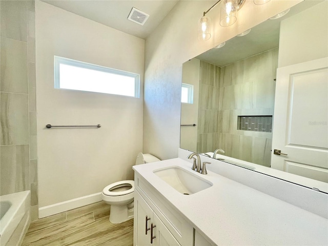 full bath with visible vents, baseboards, toilet, wood finished floors, and vanity