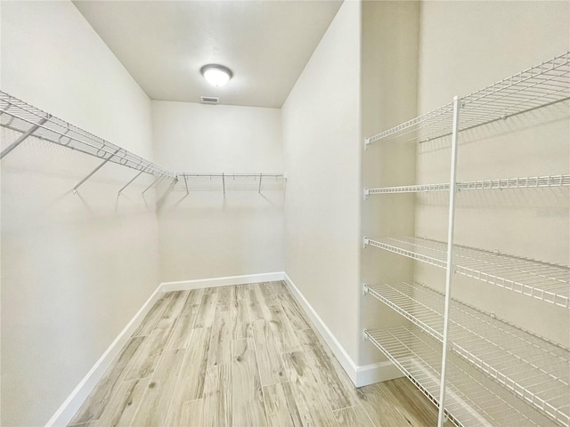 spacious closet with wood finished floors