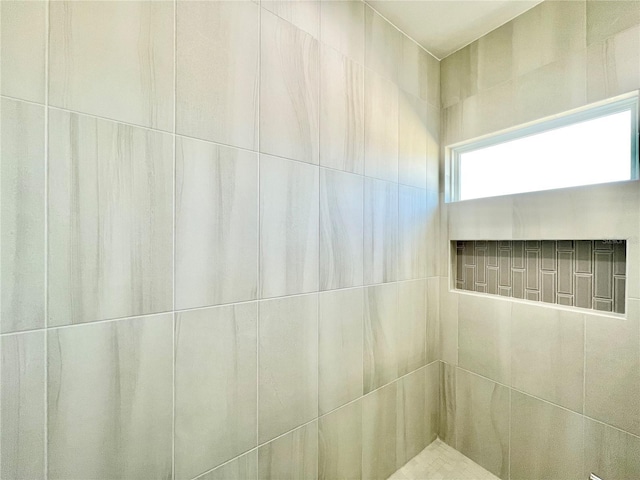 full bath with a tile shower