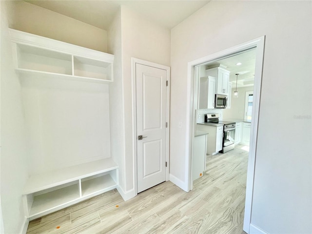 mudroom with baseboards and light wood finished floors