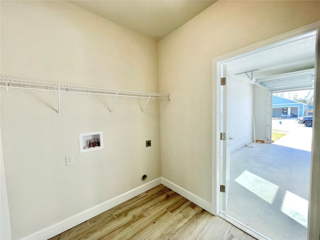 washroom featuring baseboards, hookup for an electric dryer, laundry area, washer hookup, and light wood-type flooring