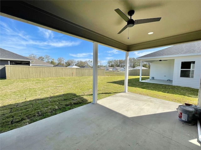 view of patio with a ceiling fan and fence