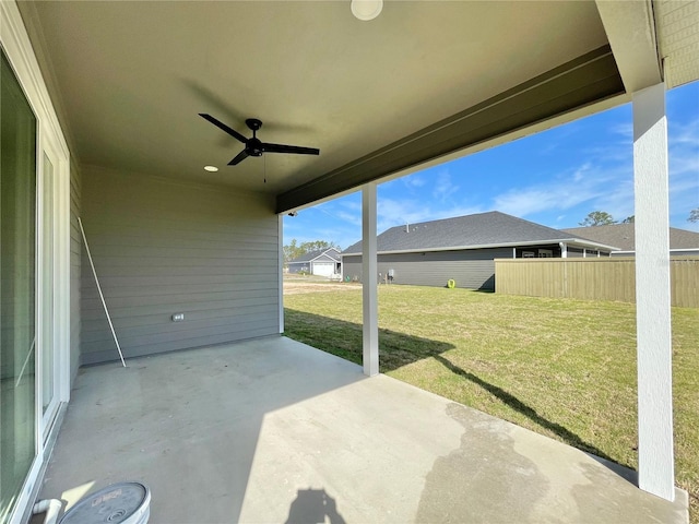 view of patio featuring ceiling fan and fence