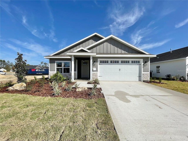 craftsman inspired home with stone siding, board and batten siding, concrete driveway, and an attached garage