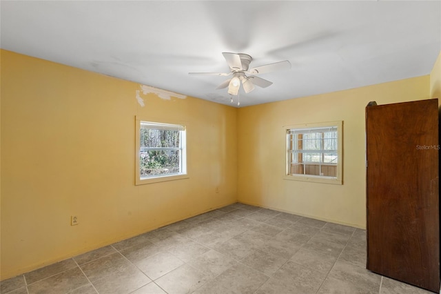 spare room featuring plenty of natural light and a ceiling fan