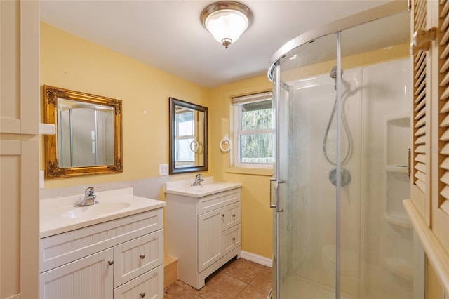 bathroom featuring a shower stall, two vanities, and a sink