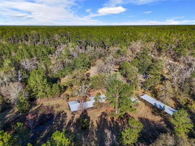 drone / aerial view featuring a forest view