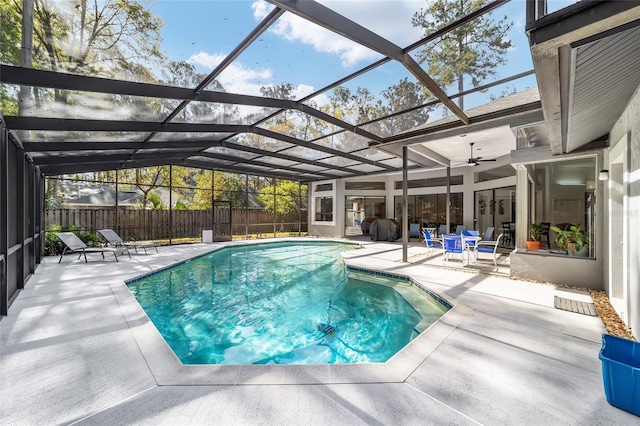 view of pool with a patio area, fence, a fenced in pool, and a lanai