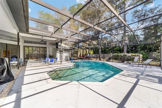 view of swimming pool featuring glass enclosure, a patio, a fenced in pool, and fence