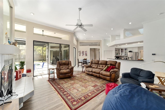 living room with recessed lighting, crown molding, and a ceiling fan