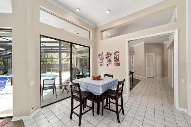 dining room with light tile patterned flooring, crown molding, baseboards, and a sunroom