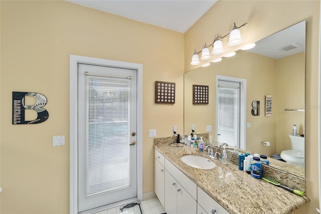 bathroom featuring visible vents, baseboards, toilet, and vanity