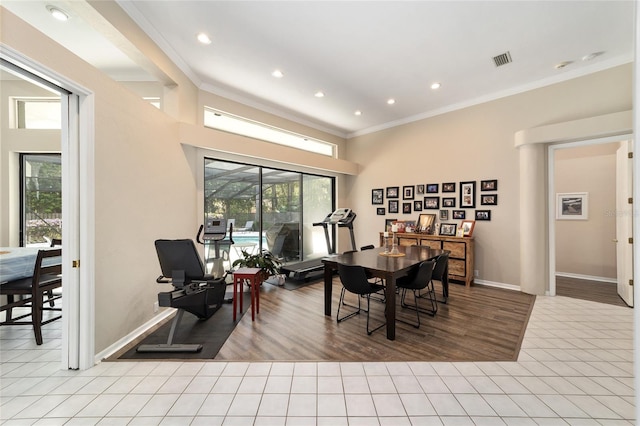 tiled dining room with visible vents, baseboards, and ornamental molding