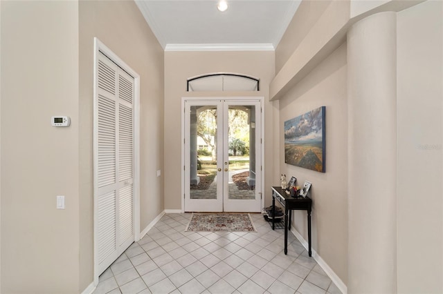 foyer entrance with crown molding, light tile patterned flooring, french doors, and baseboards