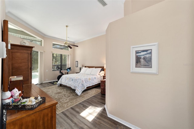 bedroom featuring visible vents, baseboards, dark wood finished floors, crown molding, and access to outside