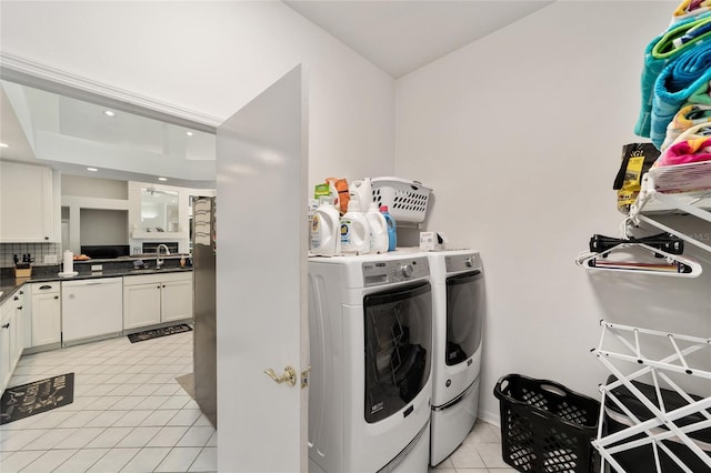 laundry area with washer and dryer, a sink, recessed lighting, light tile patterned flooring, and laundry area