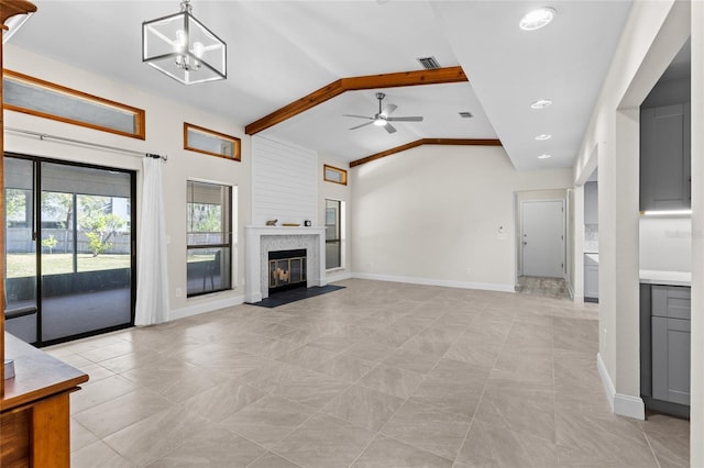 unfurnished living room featuring visible vents, baseboards, vaulted ceiling with beams, a fireplace, and ceiling fan with notable chandelier