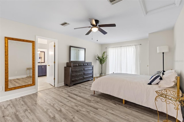 bedroom with wood finished floors, visible vents, baseboards, ceiling fan, and connected bathroom