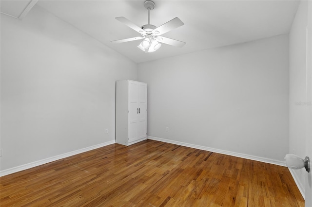 unfurnished room featuring baseboards, light wood-style floors, and ceiling fan